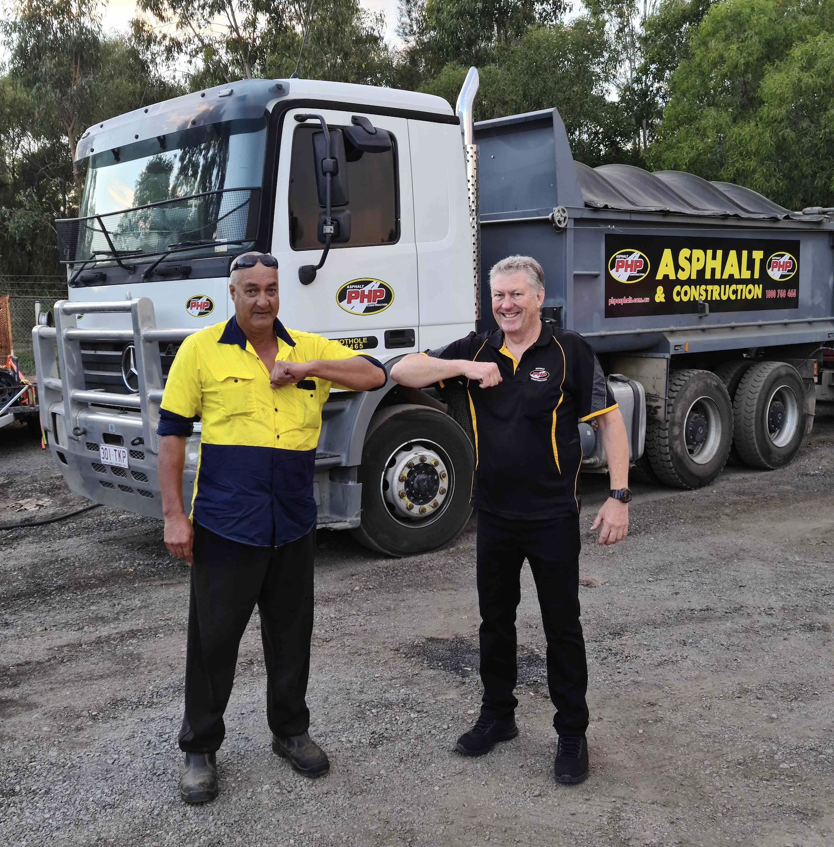 Pothole People Qld stood in front of asphalt truck on construction site