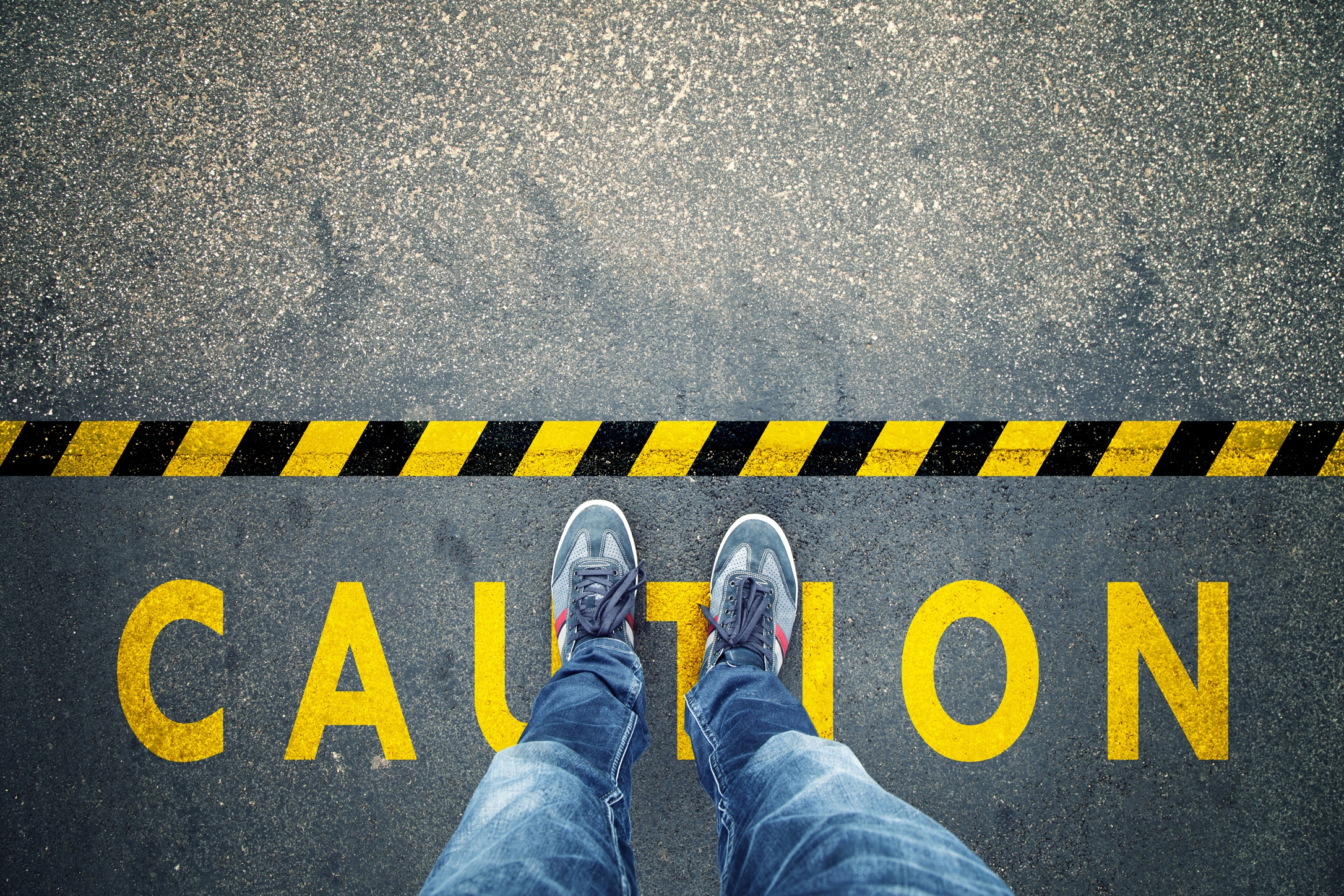 Caution sign with feet looking down at floor