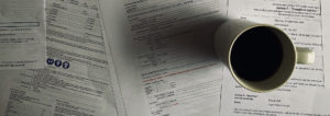 Coffee mug on top of several documents